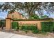 Landmark sign with the word 'Clearbrooke' on a stone wall with shrubbery at 1864 Clearbrooke Dr, Clearwater, FL 33760