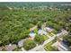 Aerial view showcasing the home's location within a lush, green neighborhood with nearby amenities at 1891 Harmony Dr, Clearwater, FL 33756