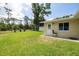 Lush green backyard featuring a patio area, storage shed, and trees at 1891 Harmony Dr, Clearwater, FL 33756