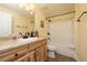Cozy bathroom with a tub/shower combo, neutral tile and vanity with ample storage at 1891 Harmony Dr, Clearwater, FL 33756