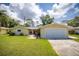 Inviting single-story home with a well-manicured lawn and a two-car garage at 1891 Harmony Dr, Clearwater, FL 33756