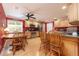 Bright kitchen with natural wood cabinets, stainless steel appliances, and a cozy breakfast nook with a backyard view at 1891 Harmony Dr, Clearwater, FL 33756