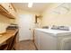 Well-equipped laundry room with washer, dryer, storage cabinets, and a convenient folding area at 1891 Harmony Dr, Clearwater, FL 33756