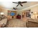 Open-concept living room with hardwood floors, ceiling fans, and comfortable seating with a view into the dining area at 1891 Harmony Dr, Clearwater, FL 33756