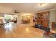 Spacious living area featuring hardwood floors, a dining table, and an exercise machine for a comfortable living experience at 1891 Harmony Dr, Clearwater, FL 33756