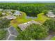 An aerial view shows the community pond surrounded by lush trees at 1902 Hanson Ct # 308, Sun City Center, FL 33573