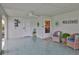 Back porch area with ceiling fan, tile floor, two entry doors and outdoor seating at 1902 Hanson Ct # 308, Sun City Center, FL 33573