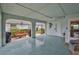 Covered porch area with ceiling fan, outdoor seating and access to the backyard and home interior at 1902 Hanson Ct # 308, Sun City Center, FL 33573