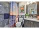 Bathroom with gray marble tile in the shower and ocean sunset scene shower curtain at 1902 Hanson Ct # 308, Sun City Center, FL 33573