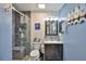 Updated bathroom featuring a glass enclosed shower, modern vanity, shiplap walls, and charming decor at 1902 Hanson Ct # 308, Sun City Center, FL 33573