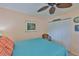 Bedroom featuring a tropical themed accent wall, light peach colored walls and a closet at 1902 Hanson Ct # 308, Sun City Center, FL 33573