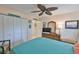 Bedroom with a TV on a wicker dresser and a tropical themed ceiling fan at 1902 Hanson Ct # 308, Sun City Center, FL 33573