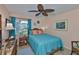Cozy bedroom featuring a tropical ceiling fan, light peach colored walls and decor accents at 1902 Hanson Ct # 308, Sun City Center, FL 33573