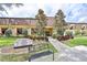 Well-maintained clubhouse entrance with lush landscaping, a bench, and a welcoming facade at 1902 Hanson Ct # 308, Sun City Center, FL 33573