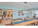A dining room with bright teal walls, custom wood table with river epoxy, and a pass-through to the kitchen at 1902 Hanson Ct # 308, Sun City Center, FL 33573