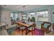 Stylish dining room featuring a unique wood table with colorful rug and natural light at 1902 Hanson Ct # 308, Sun City Center, FL 33573