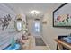 Stylish entryway with decorative fish art, light fixture, and a cushioned bench at 1902 Hanson Ct # 308, Sun City Center, FL 33573