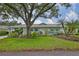 Charming single-story home with mature landscaping and a vibrant green lawn in a peaceful neighborhood at 1902 Hanson Ct # 308, Sun City Center, FL 33573