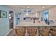 Bright kitchen boasts white cabinets, modern appliances, granite counters, and raised breakfast bar seating at 1902 Hanson Ct # 308, Sun City Center, FL 33573