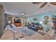 Spacious living room features a large sectional sofa, and accent rug adding warmth and color at 1902 Hanson Ct # 308, Sun City Center, FL 33573