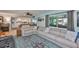Open floor plan with a modern sofa and view of the kitchen in this living room at 1902 Hanson Ct # 308, Sun City Center, FL 33573