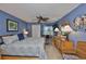 Comfortable main bedroom with wood furnishings, accent wall, ceiling fan, and lots of natural light at 1902 Hanson Ct # 308, Sun City Center, FL 33573
