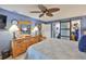 Comfortable main bedroom featuring wood furnishings, and lots of natural light and adjacent ensuite bathroom at 1902 Hanson Ct # 308, Sun City Center, FL 33573