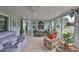 A sun room with comfortable furniture and large windows which provide plenty of natural light at 1902 Hanson Ct # 308, Sun City Center, FL 33573