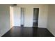 Bedroom with dark laminate flooring and two doors at 2017 Skimmer W Ct # 413, Clearwater, FL 33762