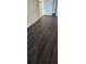 Bedroom with dark wood-look laminate flooring and white baseboards at 2017 Skimmer W Ct # 413, Clearwater, FL 33762