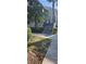 Landscaped exterior of building, featuring stairs leading to upper units and mature shrubs at 2017 Skimmer W Ct # 413, Clearwater, FL 33762