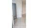 Hallway with tiled floors and an open doorway at 2017 Skimmer W Ct # 413, Clearwater, FL 33762