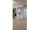Bright kitchen featuring tile flooring, cabinetry, microwave, oven, and an eat-in bar at 2017 Skimmer W Ct # 413, Clearwater, FL 33762