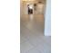 Spacious living room with tile flooring that flows into the dining area and kitchen at 2017 Skimmer W Ct # 413, Clearwater, FL 33762