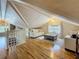 Inviting attic living room with hardwood floors, bright windows, and comfortable seating under vaulted ceilings at 231 15Th Ne Ave, St Petersburg, FL 33704