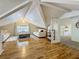 Bright attic with hardwood floors, comfortable seating area, vaulted ceilings, and a view into another room at 231 15Th Ne Ave, St Petersburg, FL 33704