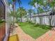 Relaxing backyard with a hammock, lush artificial grass, and tropical landscaping at 231 15Th Ne Ave, St Petersburg, FL 33704