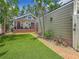Charming backyard with lush artificial grass, brick pathway, and well-manicured landscaping at 231 15Th Ne Ave, St Petersburg, FL 33704
