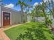 Secluded backyard oasis with artificial grass, mature palm trees, and a cozy hammock at 231 15Th Ne Ave, St Petersburg, FL 33704
