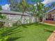 Beautiful backyard with green lawn, privacy fence, and a relaxing hammock at 231 15Th Ne Ave, St Petersburg, FL 33704