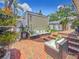 Backyard features a lounge area, a brick patio, and lush landscaping at 231 15Th Ne Ave, St Petersburg, FL 33704