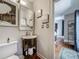 Bathroom with a small sink, toilet, and medicine cabinet, leading to a bedroom at 231 15Th Ne Ave, St Petersburg, FL 33704