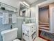 Stylish bathroom featuring a white vanity with marble countertop, glass shelving, and mosaic tile accents at 231 15Th Ne Ave, St Petersburg, FL 33704