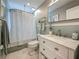 Classic bathroom with a shower-tub combo, updated vanity with white marble countertop, and mosaic tile wall at 231 15Th Ne Ave, St Petersburg, FL 33704