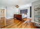 This bedroom features hardwood floors, gray walls, an area rug, curtains, and a stylish light fixture at 231 15Th Ne Ave, St Petersburg, FL 33704