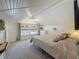 Charming bedroom with white plank ceiling, carpet, and a window overlooking the yard at 231 15Th Ne Ave, St Petersburg, FL 33704