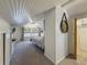 Bright bedroom featuring sloped ceilings, carpet, a large window, and an ensuite bathroom at 231 15Th Ne Ave, St Petersburg, FL 33704