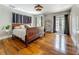 Primary bedroom features hardwood floors, a ceiling fan, and French doors to a balcony or patio at 231 15Th Ne Ave, St Petersburg, FL 33704