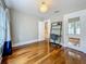 Bright bedroom featuring hardwood floors, white trim, a modern desk and a decorative light fixture at 231 15Th Ne Ave, St Petersburg, FL 33704