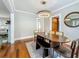 The dining room has hardwood floors, a modern fixture, and entry to other rooms at 231 15Th Ne Ave, St Petersburg, FL 33704